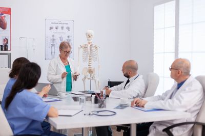 physician-senior-woman-holding-bone-structure-disc-2023-11-27-05-22-35-utc.jpg